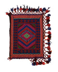 Colorful kilim rug with geometric patterns and tassels on a plain background
