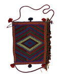 Decorative bag with geometric pattern and tassels on a white background