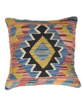 Multicolored patterned pillow with geometric design on a white background