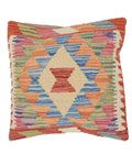 Multicolored geometric patterned pillow on a white background