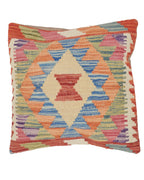 Multicolored geometric patterned pillow on a white background