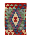 Kilim rug with geometric pattern on a red background