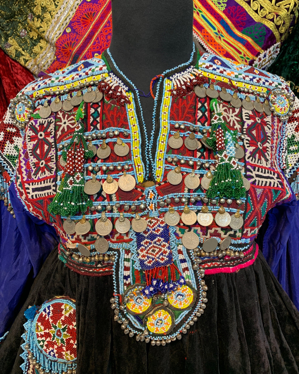 Colorful embroidered garment with intricate patterns and designs.
