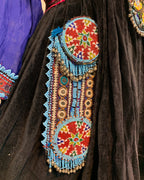 Decorative beaded clutch on a dark fabric background