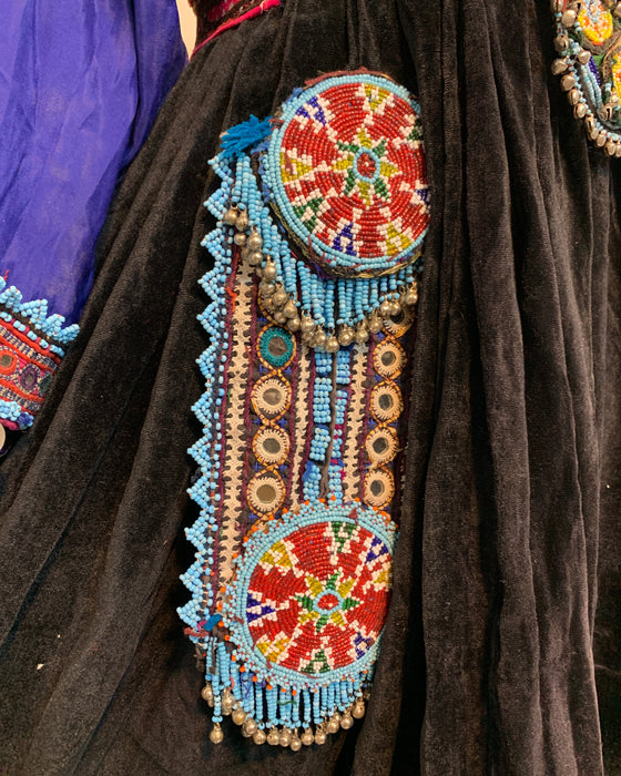 Decorative beaded clutch on a dark fabric background
