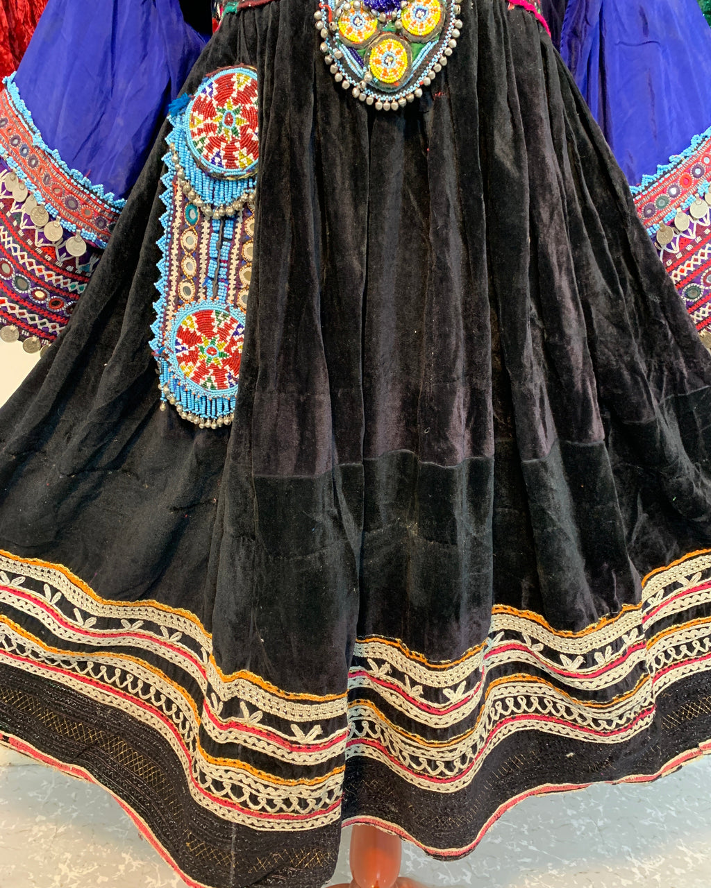 Traditional embroidered garment with black fabric and colorful patterns.