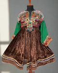 Traditional embroidered dress with colorful patterns on a textured surface