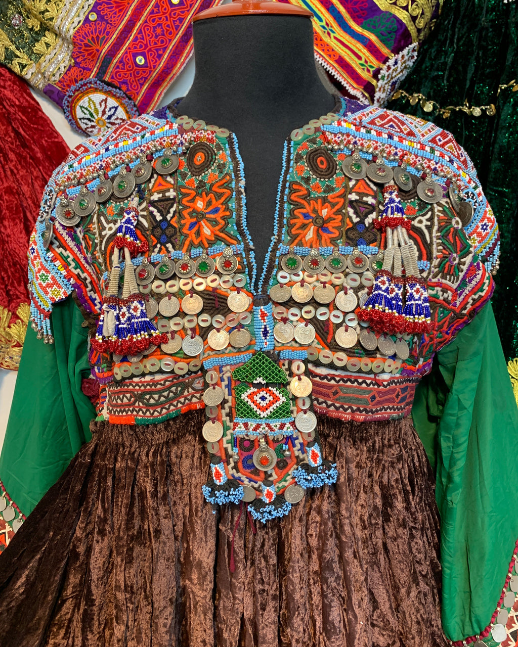 Colorful embroidered traditional garment with intricate patterns on a wooden surface