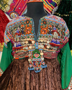 Colorful embroidered traditional garment with intricate patterns on a wooden surface