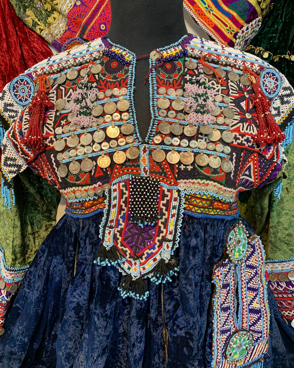 Colorful embroidered fabric with intricate patterns and embellishments.