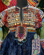 Colorful embroidered fabric with intricate patterns and embellishments.