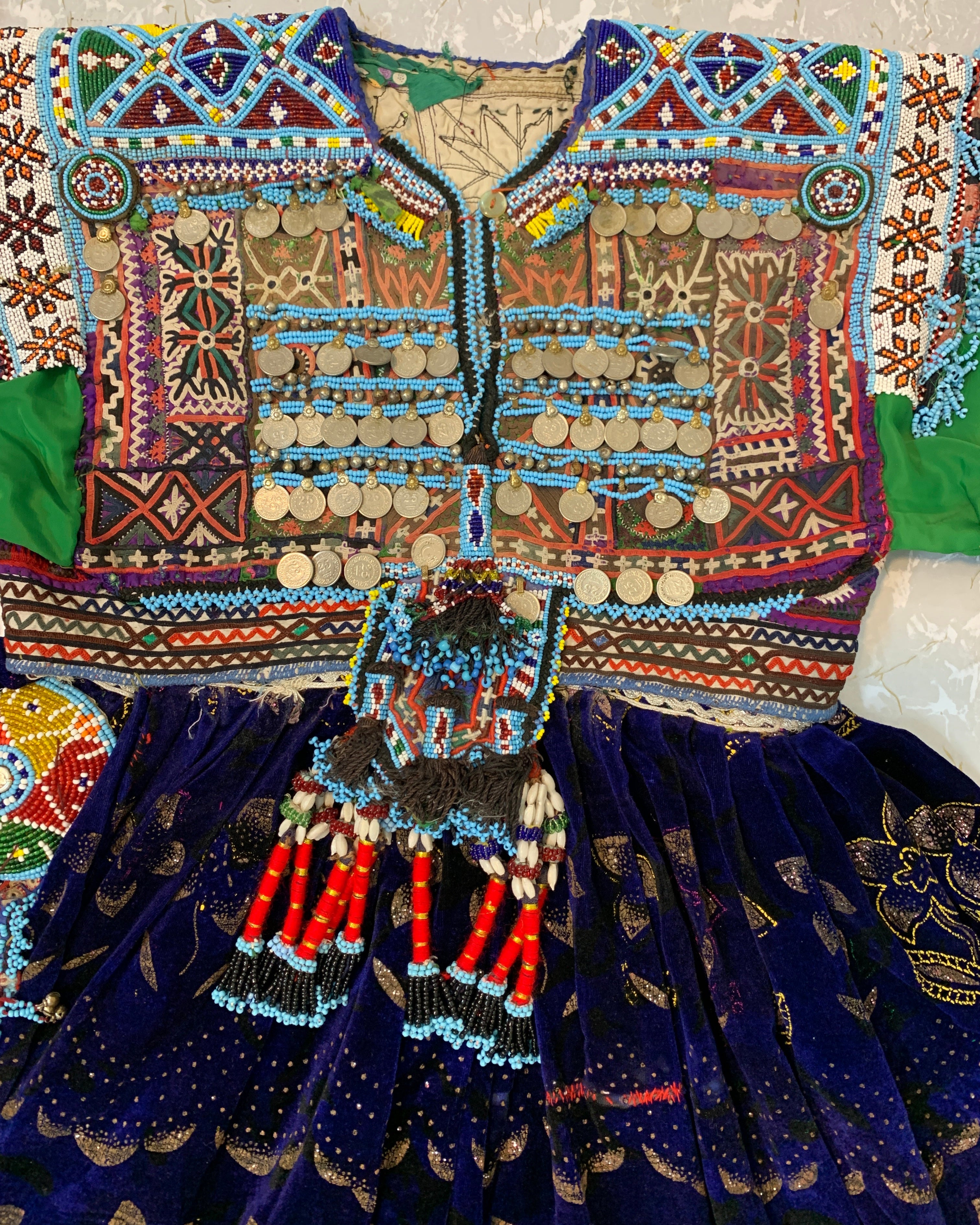 Colorful embroidered fabric with intricate patterns on a neutral background