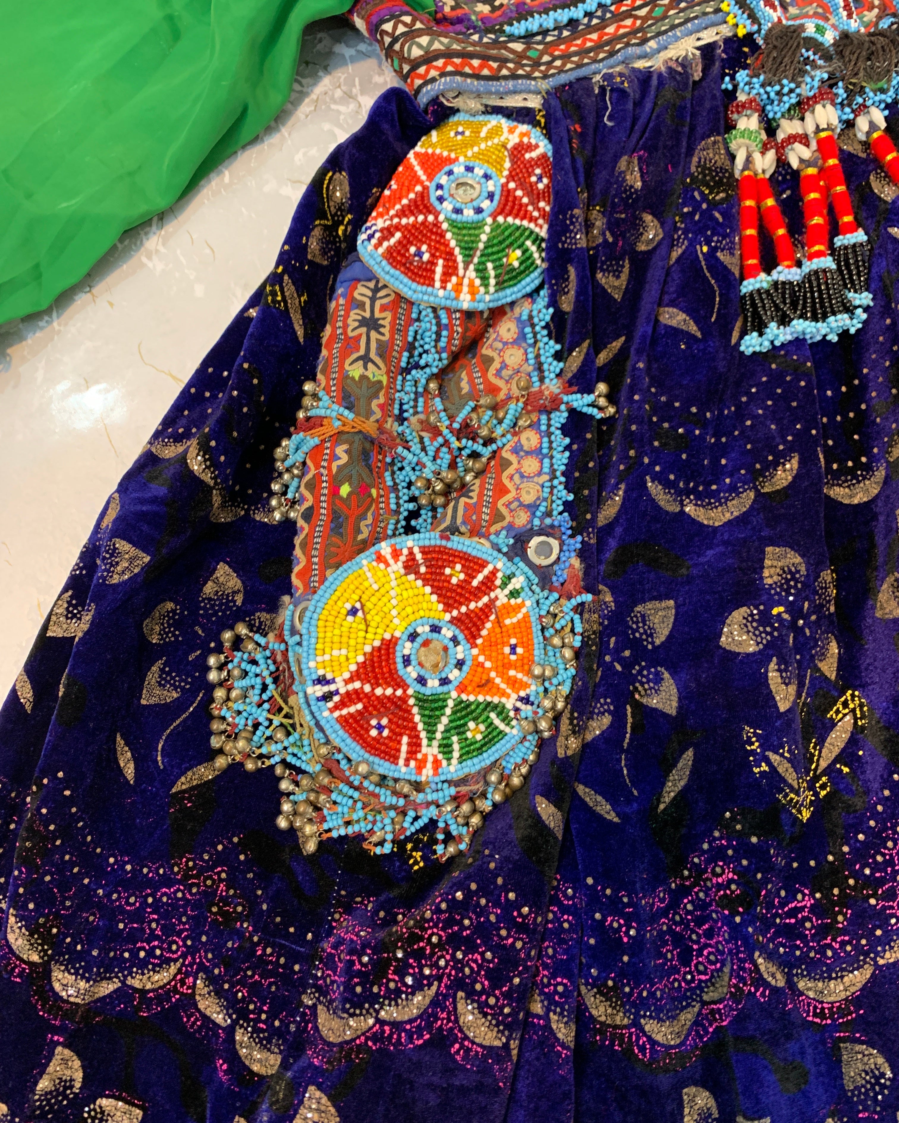Colorful beaded jewelry on a dark blue fabric background