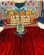 Colorful embroidered garment with intricate patterns on a red fabric background