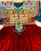 Colorful embroidered garment with intricate patterns on a red fabric background