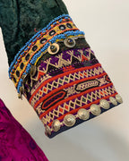 Colorful embroidered fabric with patterns and buttons on a white background