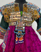 Colorful traditional outfit with intricate patterns and embellishments on a plain background