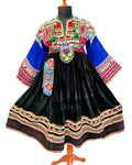 Traditional embroidered dress on a mannequin with colorful background