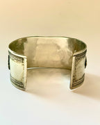 Silver bracelet on a beige background