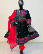 Traditional embroidered outfit with a red dupatta on a mannequin against a white background