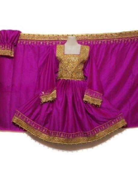A traditional Afghan brides' dress in pink color with golden embroidery and mirrors.