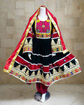 Traditional outfit with red, black, and gold colors on a mannequin against a colorful background.