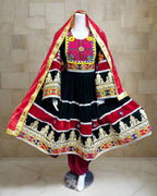 Traditional outfit with red, black, and gold colors on a mannequin against a colorful background.
