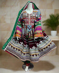 Colorful traditional dress on a mannequin with a vibrant background of various garments.