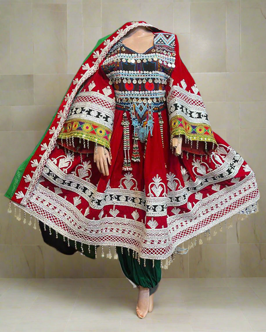 Traditional embroidered dress with intricate patterns on a mannequin against a colorful background.
