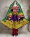 Colorful traditional dress with intricate patterns on a mannequin against a vibrant background.