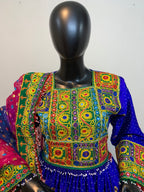 Colorful embroidered fabric on a mannequin against a white background