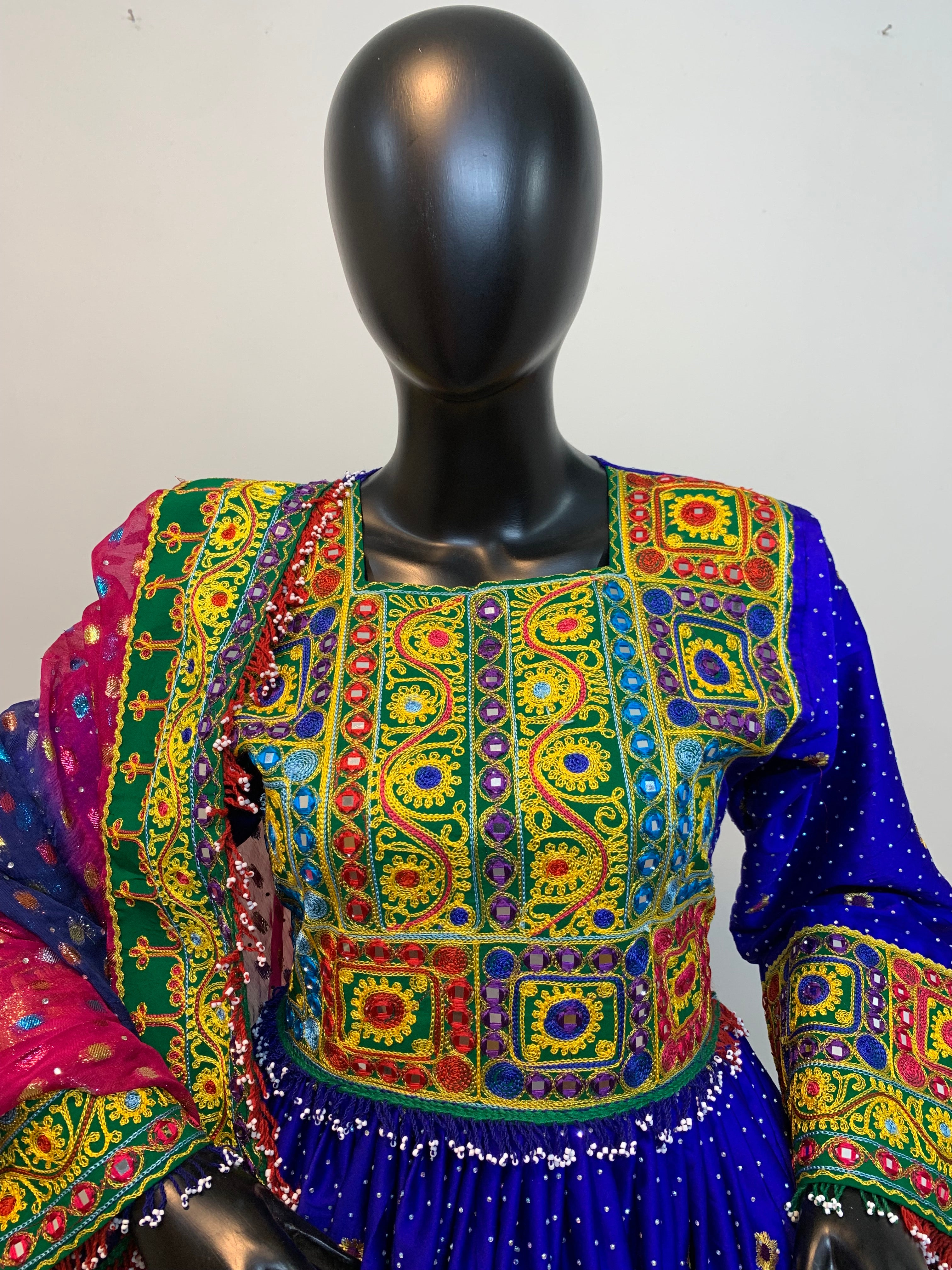 Colorful embroidered fabric on a mannequin against a white background
