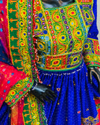 Colorful traditional outfit with intricate patterns on a mannequin.