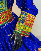 Colorful embroidered sleeve with intricate patterns on a blue fabric background
