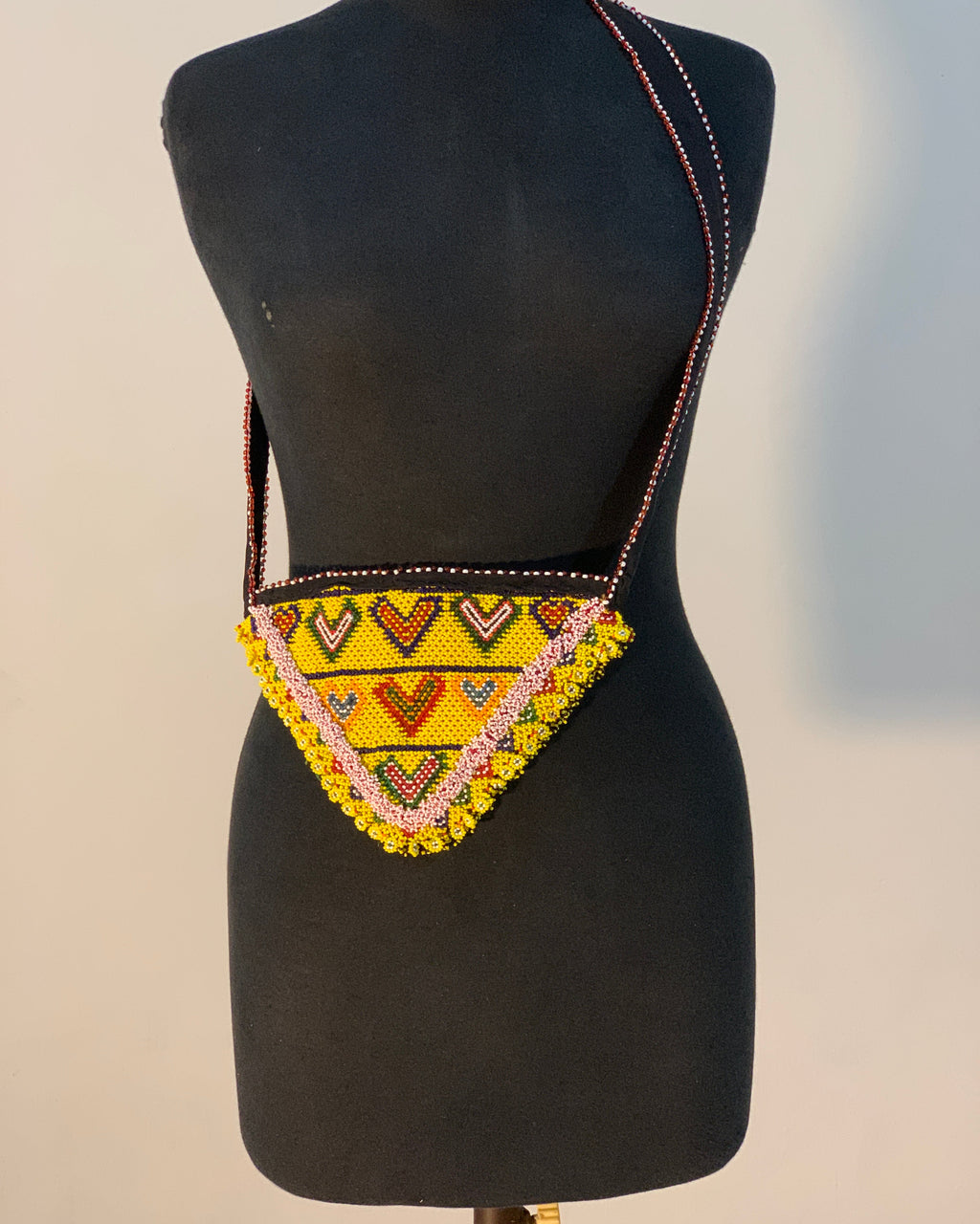 Black saddle pad with a colorful geometric pattern on a neutral background